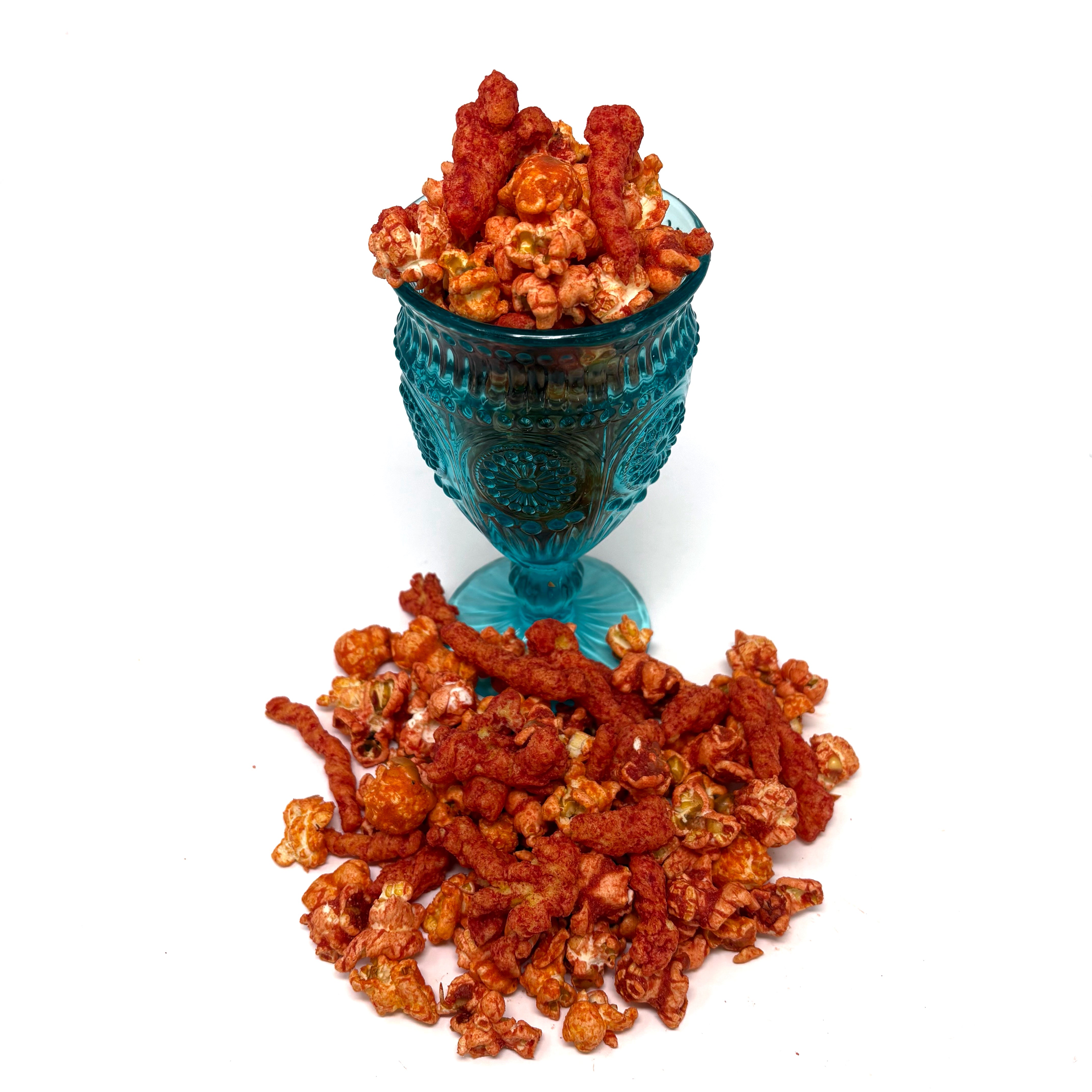 Our Eat My Dust Popcorn is a crave-worthy mix of White Cheddar and Better Cheddar popcorn that is coated in a light layer of fiery Hot Cheetos dust for a bold, cheesy heat that hits just right. Topped off with Hot Cheeto Dust and whole Hot Cheetos sprinkled throughout.