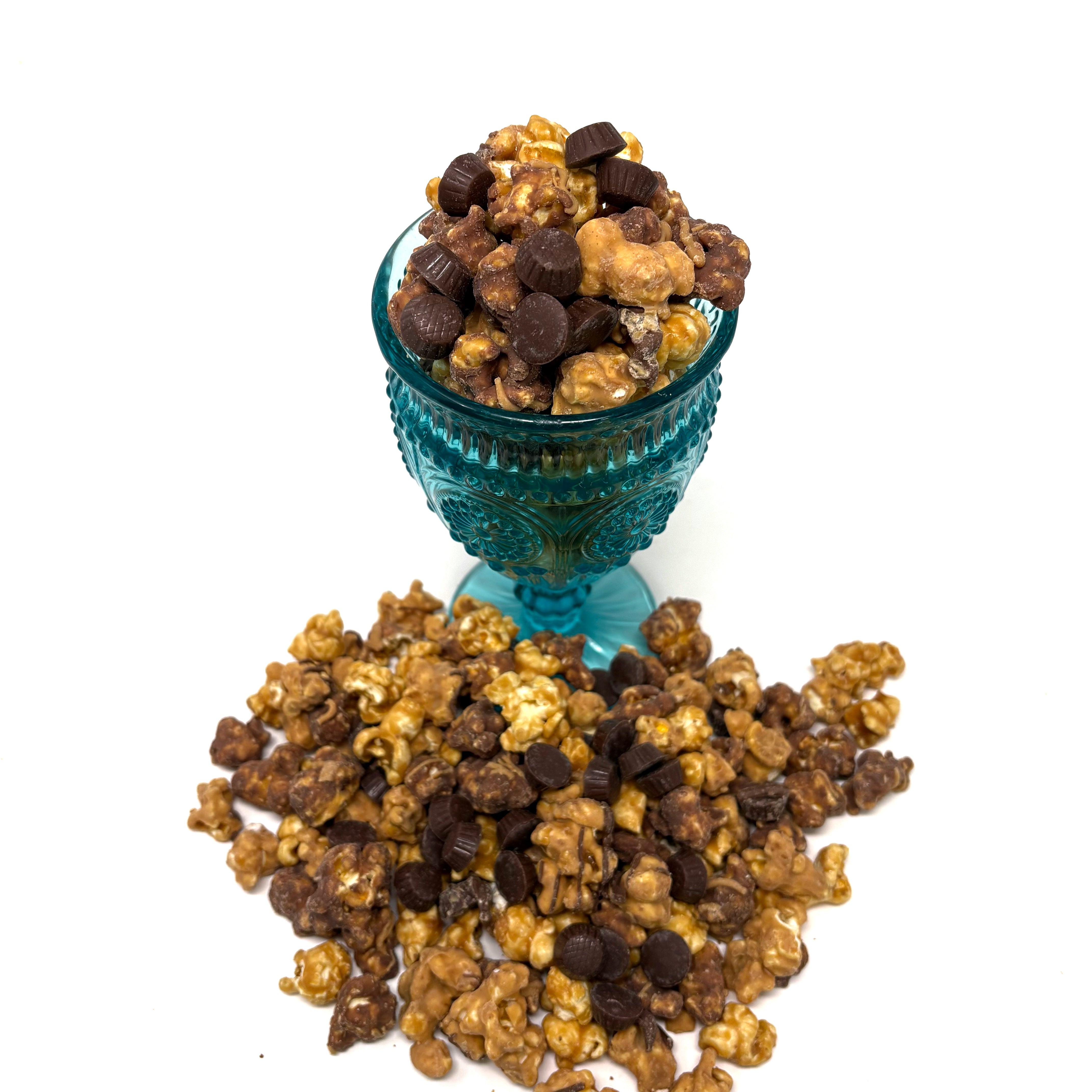 Our Ultimate Peanut Butter Cup Popcorn includes a blend of milk chocolate popcorn, peanut butter chocolate popcorn, and salted vanilla popcorn. Finished off with mini peanut butter cups sprinkled throughout.