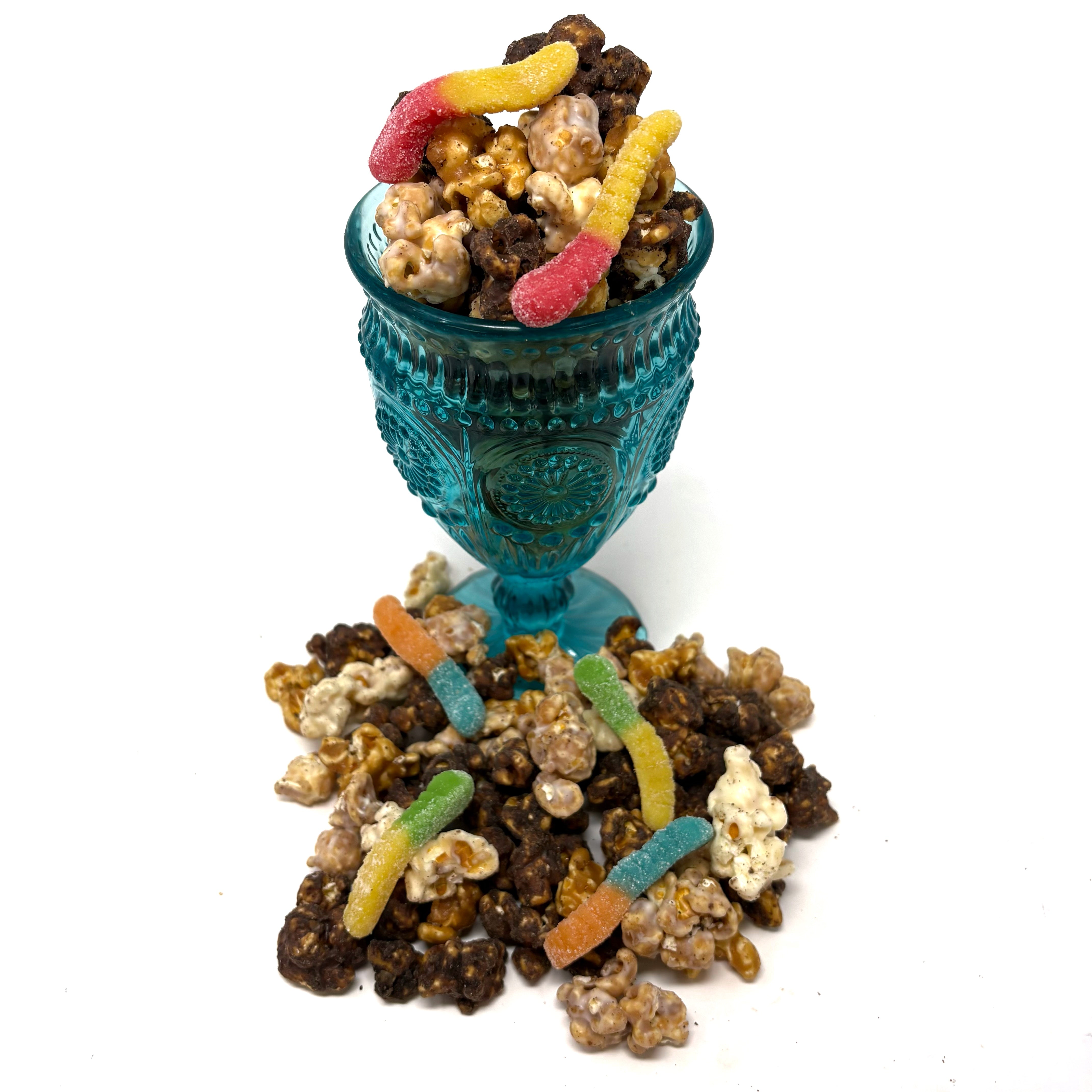 Our Iowa Dirt Cake Popcorn has our cream cheese chocolate popcorn, chocolate covered vanilla salted caramel popcorn, and our buttery vanilla salted caramel popcorn. All dusted in Oreo dust and sprinkled with a few gummy worms.