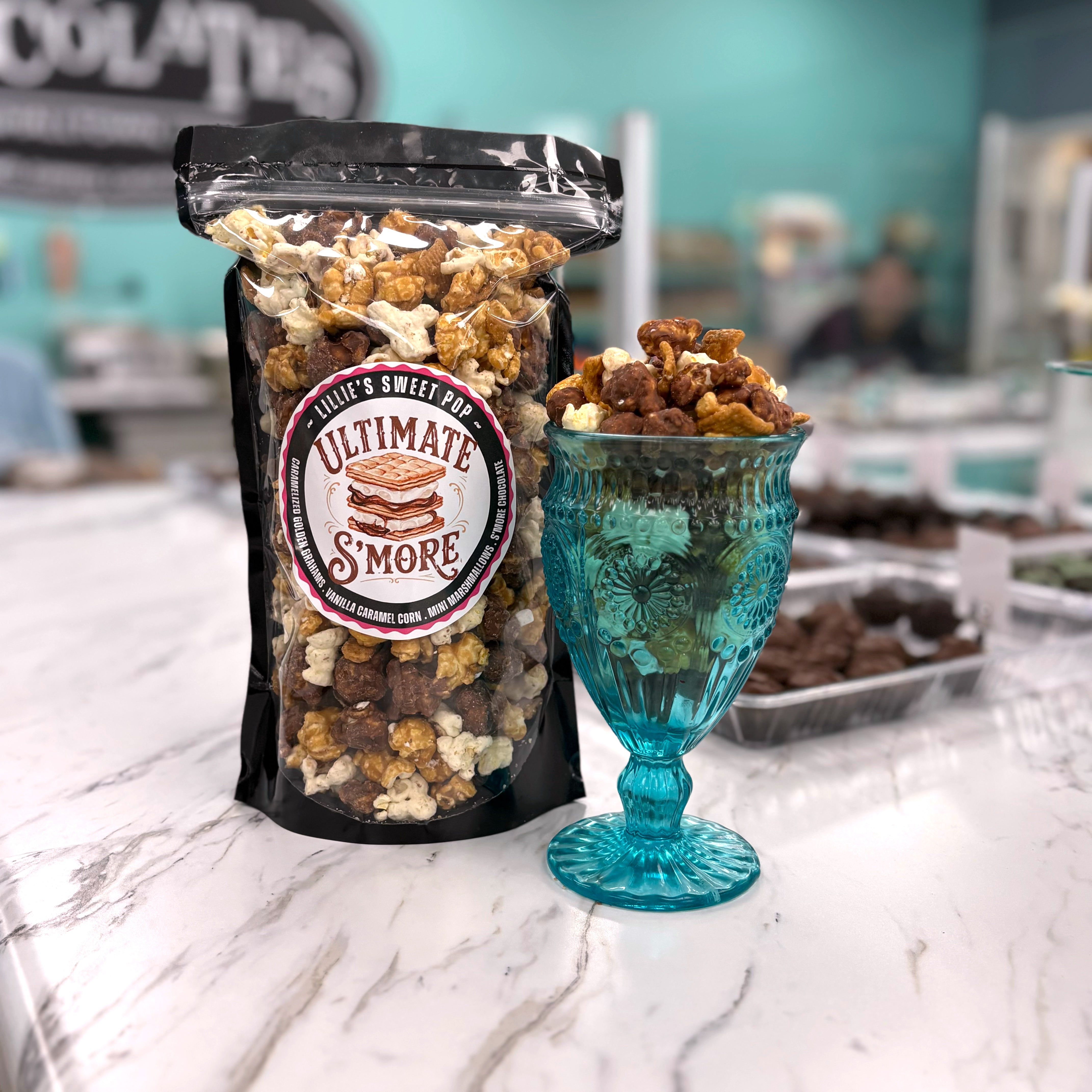 Ultimate S'more popcorn includes our salted vanilla caramel popcorn tossed with gooey s’mores chocolate, golden toasted marshmallows, and crunchy bits of Golden Grahams cooked right in with our caramel.